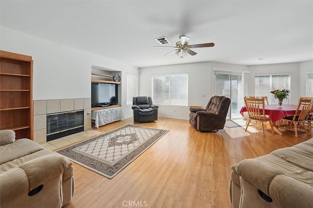 28652 Deer Springs Dr, Saugus, CA 91390 - living area featuring ceiling fan, wood finished floors, and a fireplace