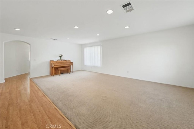 28652 Deer Springs Dr, Saugus, CA 91390 - spare room featuring recessed lighting, arched walkways, and light colored carpet