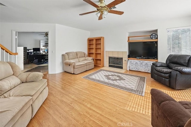 28652 Deer Springs Dr, Saugus, CA 91390 - living room with a ceiling fan, wood finished floors, stairs, and a tiled fireplace