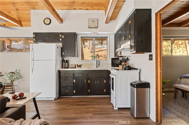 32903 Canyon Dr, Green Valley Lake, CA 92341 - kitchen featuring freestanding refrigerator, a sink, beamed ceiling, stove, and black microwave
