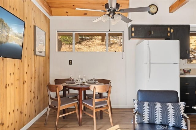 32903 Canyon Dr, Green Valley Lake, CA 92341 - dining room with light wood-type flooring, ceiling fan, wood walls, and baseboards