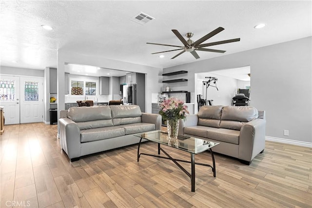 15074 Willow St, Hesperia, CA 92345 - living area with light wood-style flooring, ceiling fan, baseboards, a textured ceiling, and recessed lighting