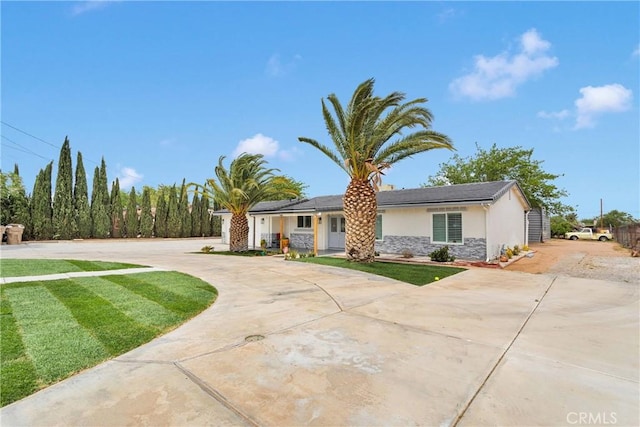 15074 Willow St, Hesperia, CA 92345 - view of front of home with stucco siding, stone siding, curved driveway, and a front yard