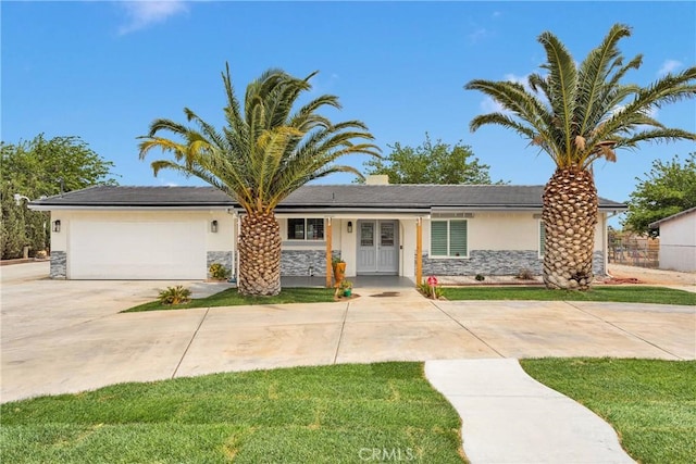 15074 Willow St, Hesperia, CA 92345 - view of front facade featuring stone siding, stucco siding, concrete driveway, and a garage