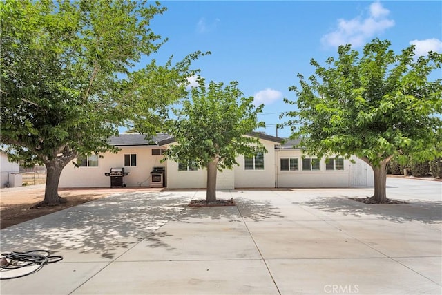 15074 Willow St, Hesperia, CA 92345 - back of house featuring concrete driveway and stucco siding