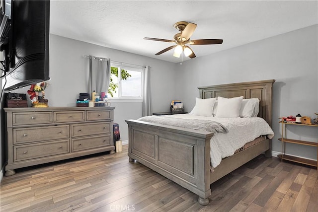 15074 Willow St, Hesperia, CA 92345 - bedroom featuring light wood-style floors, baseboards, and ceiling fan