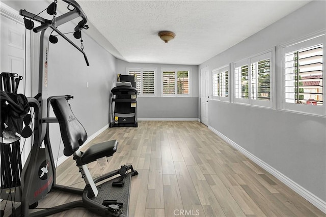 15074 Willow St, Hesperia, CA 92345 - exercise room with wood finished floors, baseboards, and a textured ceiling