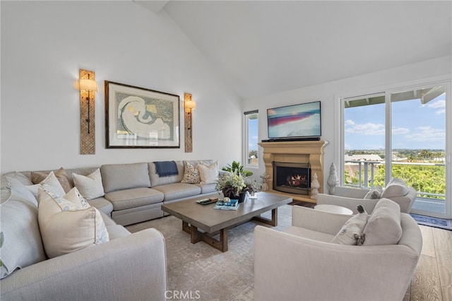 45 Northampton Ct, Newport Beach, CA 92660 - living area featuring healthy amount of natural light, a lit fireplace, high vaulted ceiling, and wood finished floors