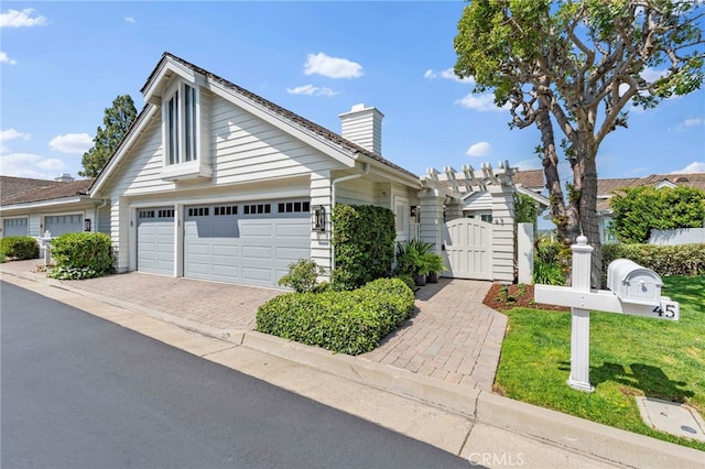 45 Northampton Ct, Newport Beach, CA 92660 - view of front of house featuring a gate, a chimney, an attached garage, and driveway