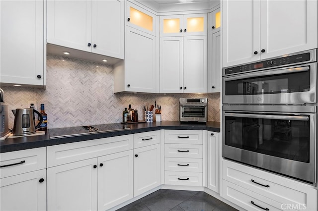 45 Northampton Ct, Newport Beach, CA 92660 - kitchen with double oven, black electric stovetop, dark tile patterned floors, white cabinets, and backsplash