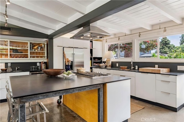 3137 Lees Ave, Long Beach, CA 90808 - kitchen with appliances with stainless steel finishes, dark countertops, finished concrete flooring, white cabinets, and beamed ceiling