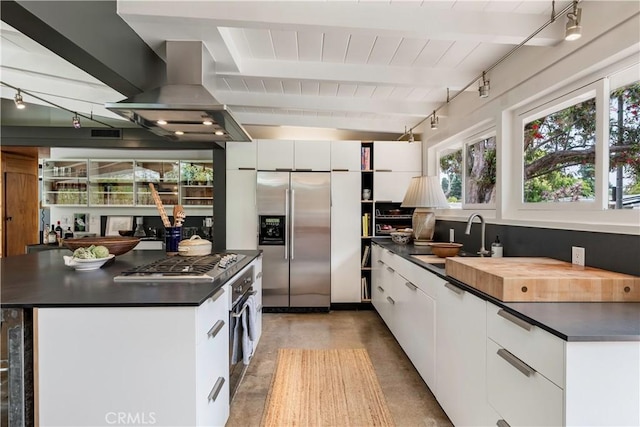 3137 Lees Ave, Long Beach, CA 90808 - kitchen featuring appliances with stainless steel finishes, a sink, dark countertops, white cabinets, and beamed ceiling