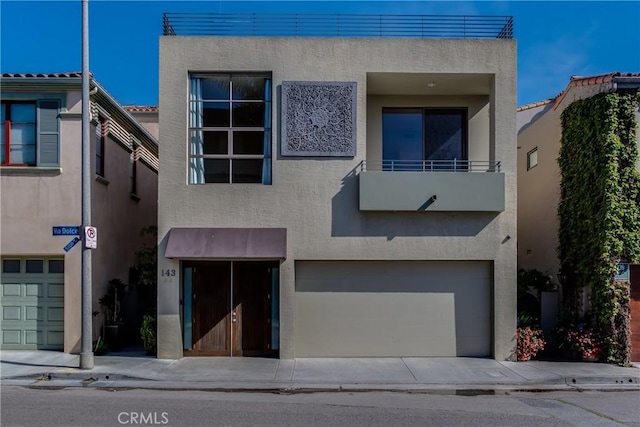 143 Union Jack Mall, Marina Del Rey, CA 90292 - view of front of property with stucco siding, an attached garage, and a balcony