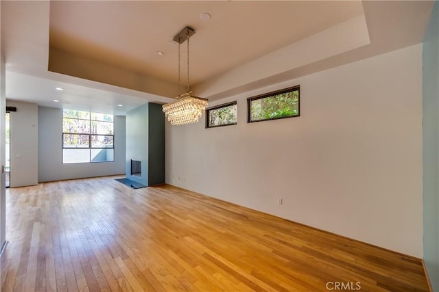 143 Union Jack Mall, Marina Del Rey, CA 90292 - unfurnished dining area with light wood-type flooring, a raised ceiling, and a chandelier