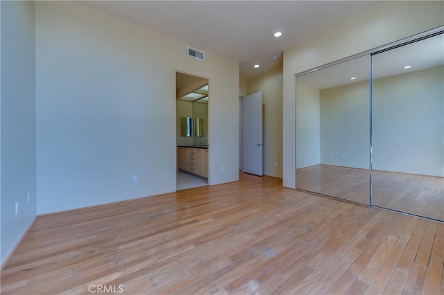 143 Union Jack Mall, Marina Del Rey, CA 90292 - unfurnished bedroom featuring light wood-type flooring, a closet, recessed lighting, and ensuite bath