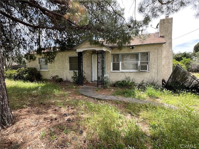 4004 N 3rd Ave, San Bernardino, CA 92407 - bungalow with stucco siding and a chimney