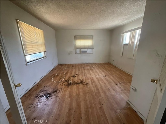 4004 N 3rd Ave, San Bernardino, CA 92407 - empty room featuring hardwood / wood-style floors, a textured ceiling, and cooling unit
