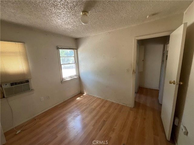4004 N 3rd Ave, San Bernardino, CA 92407 - unfurnished bedroom featuring light wood-type flooring, a textured ceiling, and cooling unit
