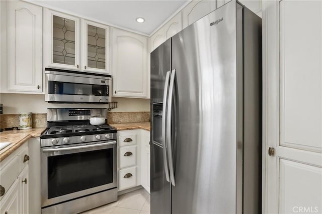 2800 Plaza Del Amo 458, Torrance, CA 90503 - kitchen with appliances with stainless steel finishes, light tile patterned floors, glass insert cabinets, white cabinets, and recessed lighting