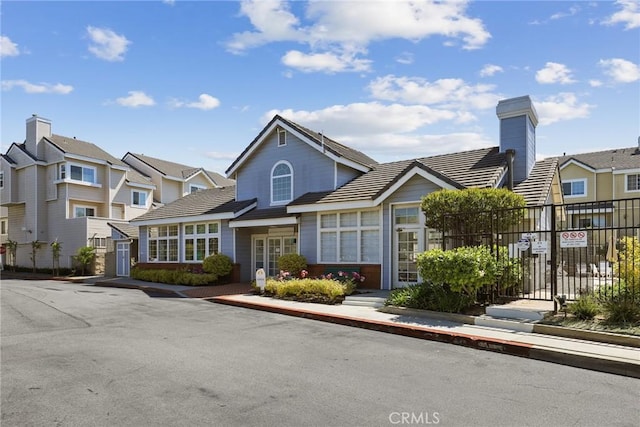 2800 Plaza Del Amo 458, Torrance, CA 90503 - view of front of property with fence, a residential view, and a tiled roof