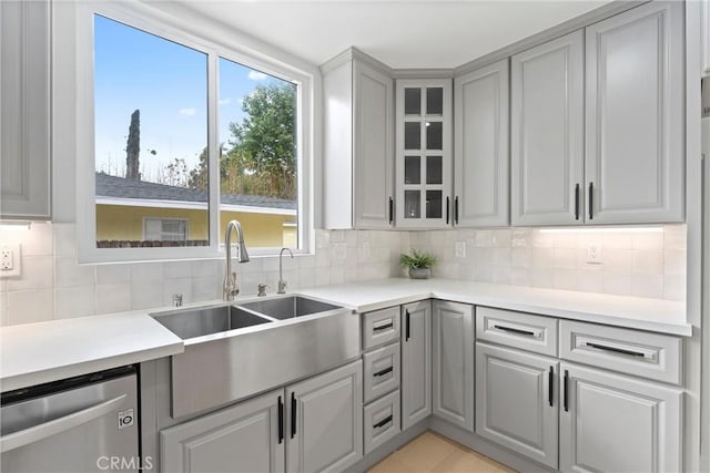 420 W Bennett Ave, Glendora, CA 91741 - kitchen featuring stainless steel dishwasher, a sink, gray cabinets, backsplash, and glass insert cabinets