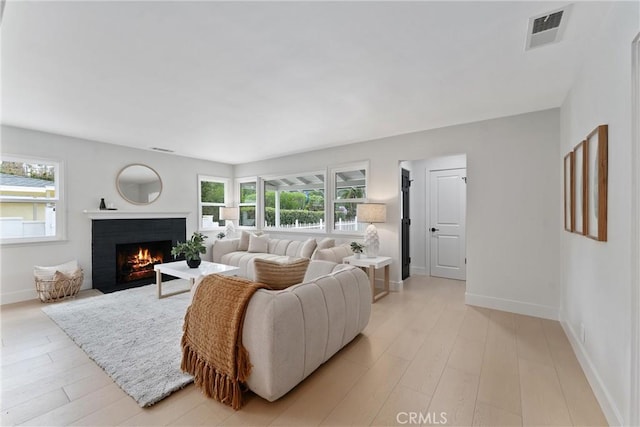 420 W Bennett Ave, Glendora, CA 91741 - living area with healthy amount of natural light, a brick fireplace, baseboards, and light wood-style floors