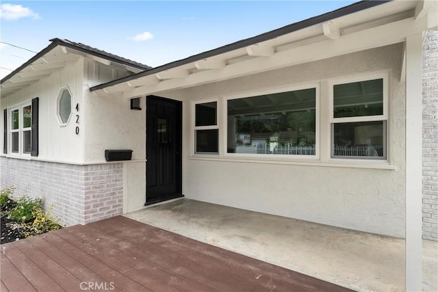 420 W Bennett Ave, Glendora, CA 91741 - doorway to property featuring brick siding, stucco siding, and a wooden deck