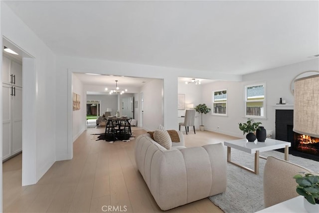 420 W Bennett Ave, Glendora, CA 91741 - living room featuring a fireplace, a chandelier, baseboards, and light wood-style floors