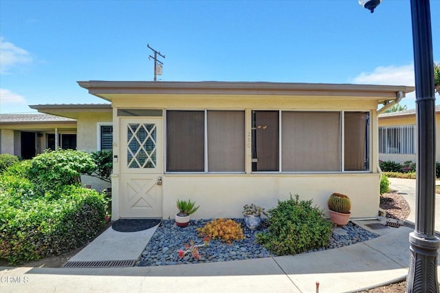 property entrance with stucco siding