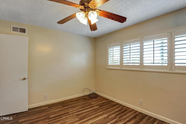 spare room featuring baseboards, wood finished floors, a textured ceiling, and ceiling fan