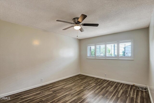 unfurnished room with dark wood-type flooring, a textured ceiling, baseboards, and ceiling fan