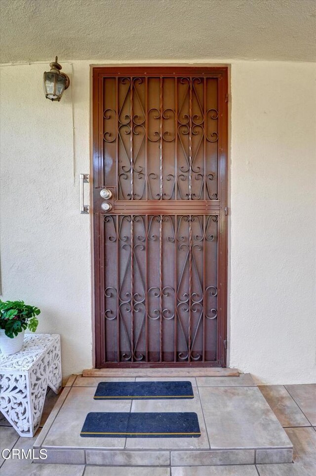 doorway to property with stucco siding