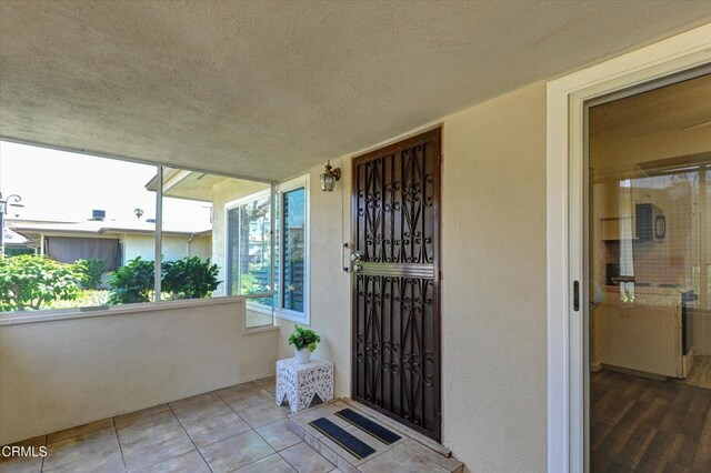 property entrance with stucco siding