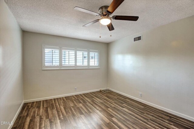 empty room featuring wood finished floors, a textured ceiling, baseboards, and a ceiling fan