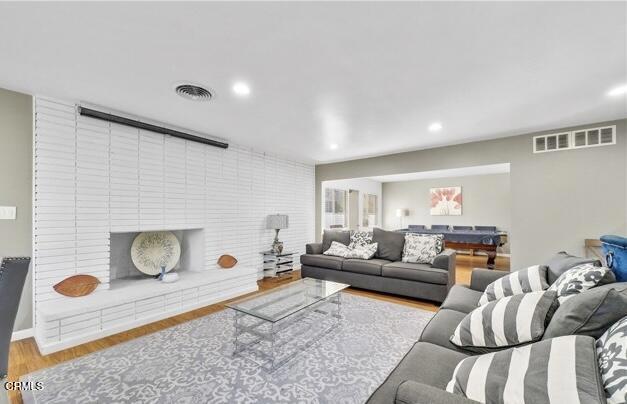 living area featuring wood finished floors and recessed lighting