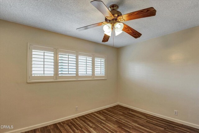 spare room featuring baseboards, dark wood-style flooring, a textured ceiling, and ceiling fan