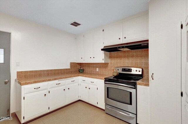 kitchen featuring stainless steel range with electric stovetop, under cabinet range hood, backsplash, and white cabinetry