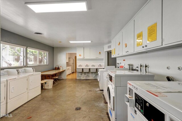 communal laundry room with separate washer and dryer