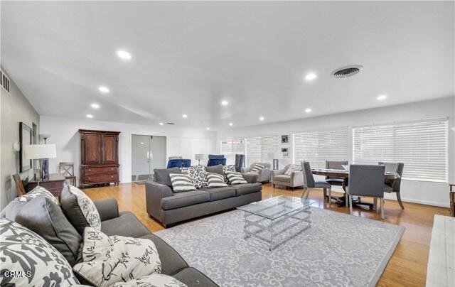 living room with recessed lighting and light wood-type flooring