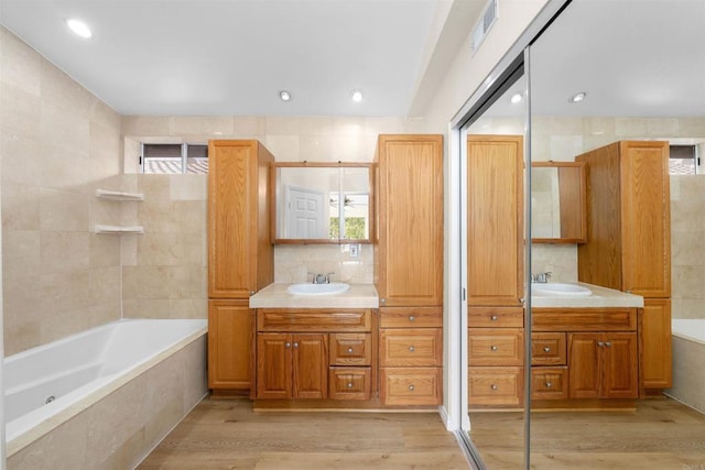 11354 Via Rancho San Diego Unit J, El Cajon, CA 92019 - bathroom with plenty of natural light, a bath, wood finished floors, and recessed lighting