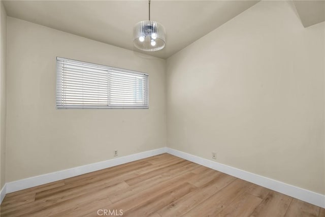 1517 Steinhart Ave, Redondo Beach, CA 90278 - empty room featuring baseboards, light wood-style flooring, and a chandelier