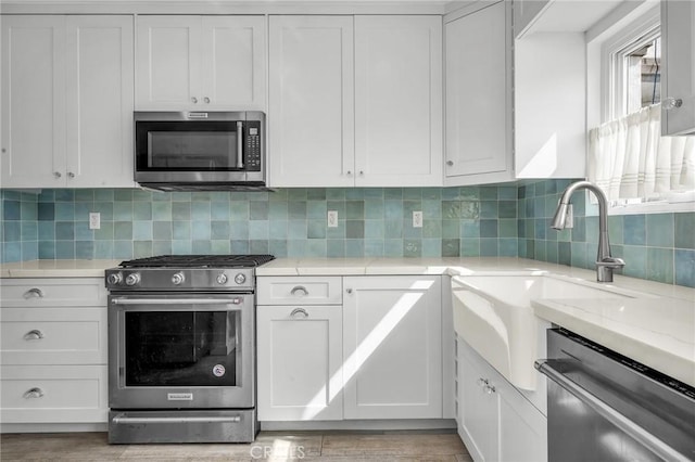 1517 Steinhart Ave, Redondo Beach, CA 90278 - kitchen with stainless steel appliances, white cabinetry, backsplash, and light stone countertops