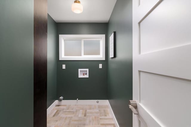 clothes washing area featuring washer hookup and baseboards