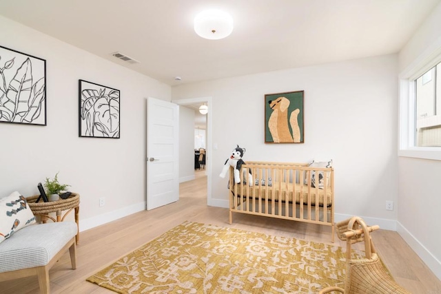 bedroom with wood finished floors and baseboards