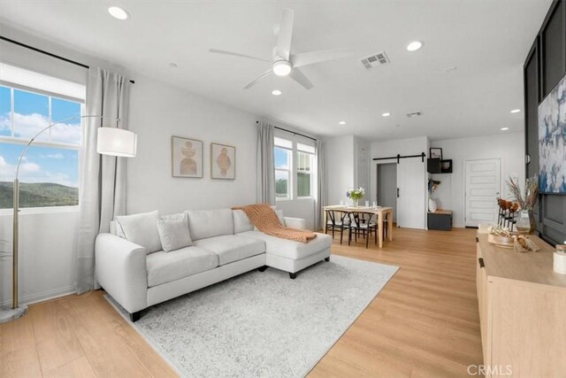 10243 Graphite St, Spring Valley, CA 91977 - living area with a barn door, light wood-type flooring, ceiling fan, and recessed lighting