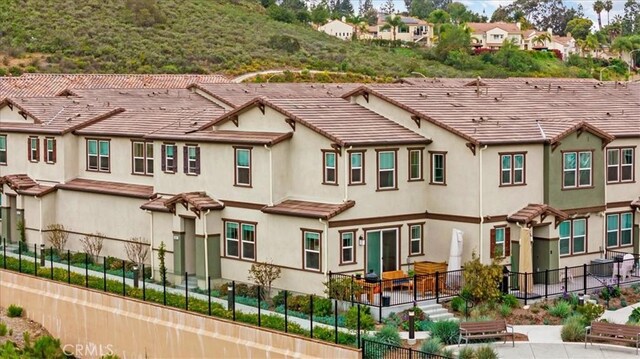 10243 Graphite St, Spring Valley, CA 91977 - back of property featuring fence, stucco siding, and a tiled roof