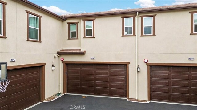 10243 Graphite St, Spring Valley, CA 91977 - view of front facade with a garage and stucco siding