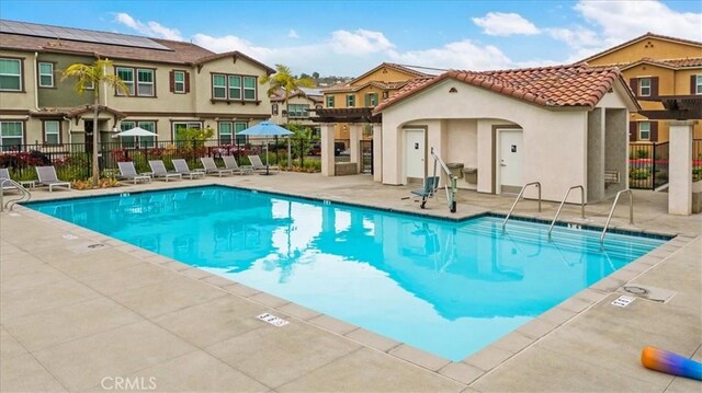 10243 Graphite St, Spring Valley, CA 91977 - community pool with fence, a patio area, and a residential view