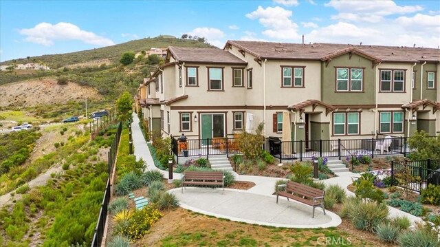 10243 Graphite St, Spring Valley, CA 91977 - rear view of house featuring fence, stucco siding, and a mountain view