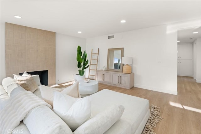 1825 W Carlton Pl, Santa Ana, CA 92704 - living room with light wood-type flooring, recessed lighting, a large fireplace, and baseboards